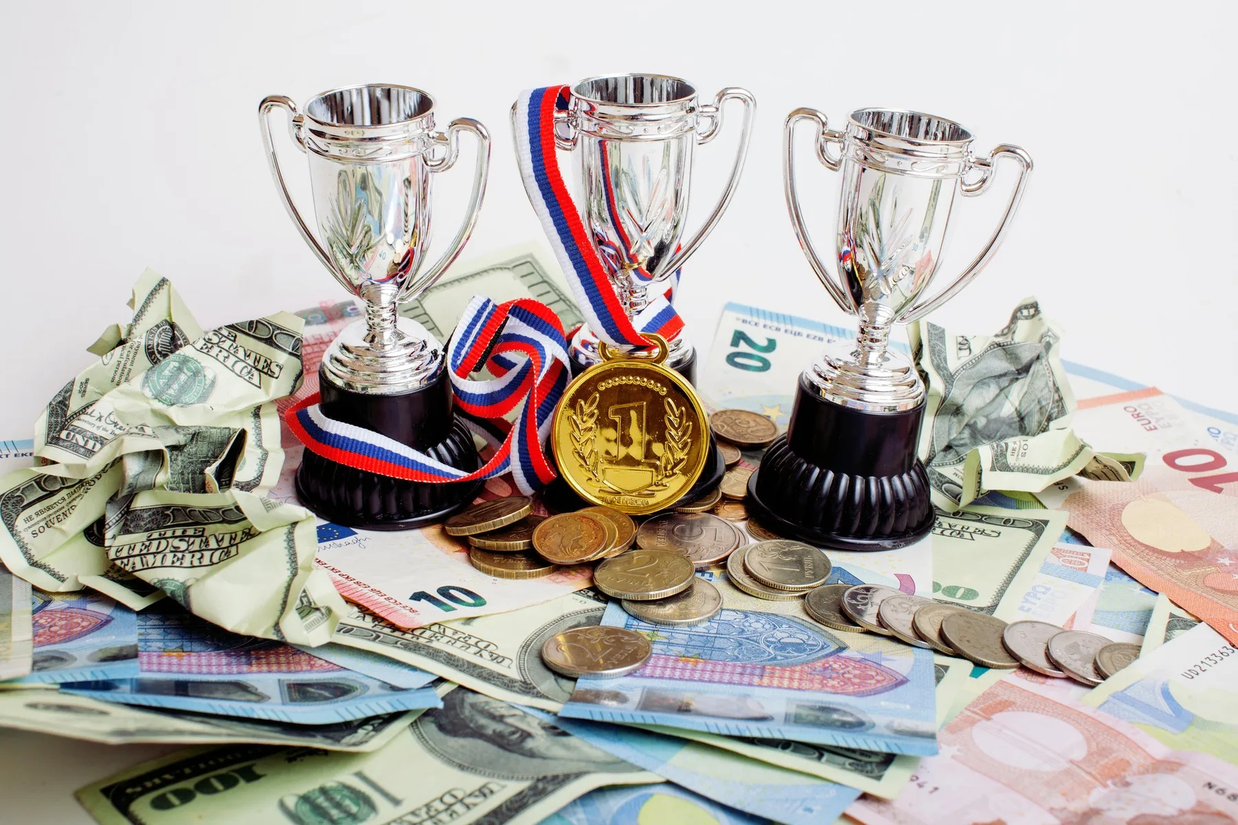 Sport winning concept: three cups among diverse currencies euro, dollar, rubl, gold medal first place close up, Image: 280999403, License: Royalty-free, Restrictions: , Model Release: no, Credit line: Profimedia, Alamy
